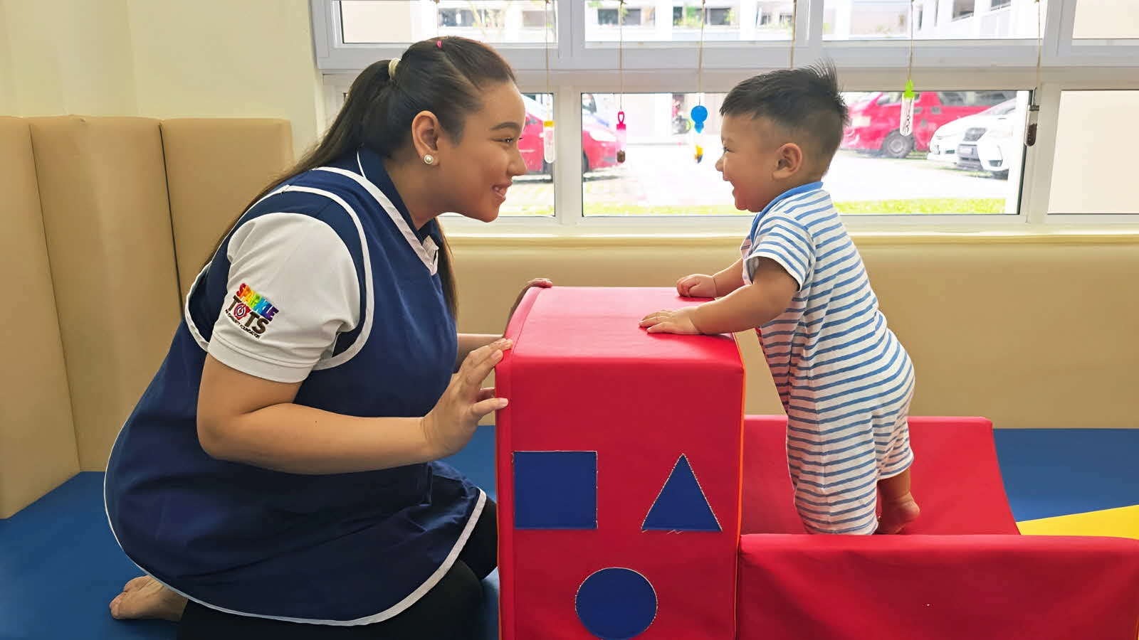 Educators-Pedagogical-Practices-Image-of-the-child-MAIN An educator and child play together in a preschool’s soft-play jungle gym, building the child’s competence and capabilities.
